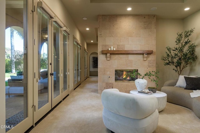 11113 Rocky High Rd, Santa Rosa, CA 93012 - living room featuring french doors, recessed lighting, light colored carpet, a tile fireplace, and arched walkways