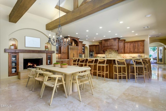 11113 Rocky High Rd, Santa Rosa, CA 93012 - dining space with recessed lighting, beamed ceiling, a tiled fireplace, and arched walkways