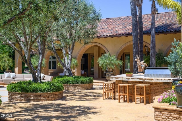 11113 Rocky High Rd, Santa Rosa, CA 93012 - view of front of property with a bar, exterior kitchen, a patio, stucco siding, and a tile roof