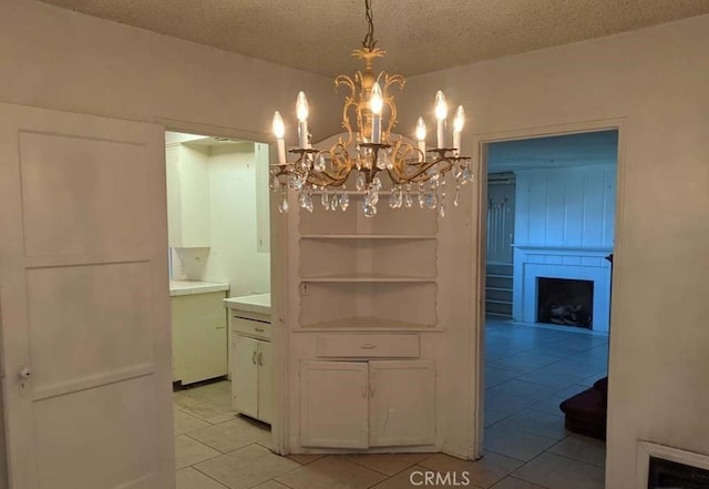 332 W Laurel, Compton, CA 90220 - dining space featuring light tile patterned flooring, a chandelier, a fireplace, and a textured ceiling
