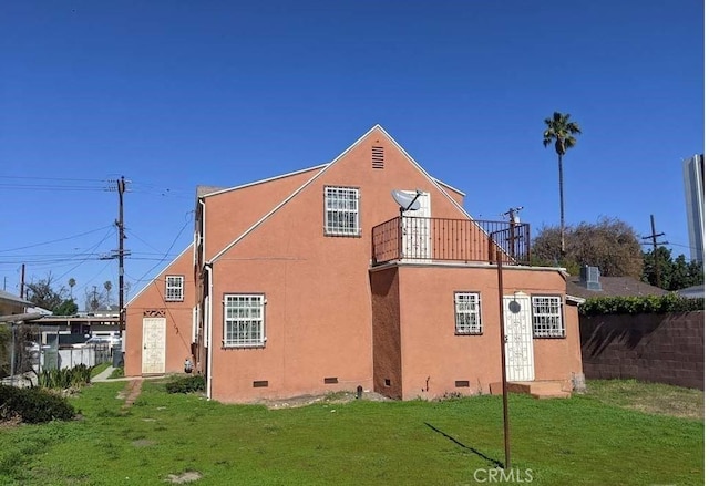 332 W Laurel, Compton, CA 90220 - view of home's exterior featuring crawl space, a balcony, a yard, and stucco siding