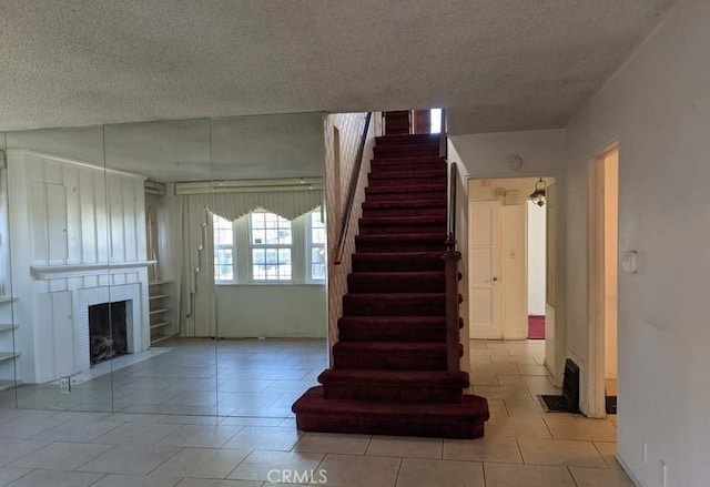 332 W Laurel, Compton, CA 90220 - stairway featuring a textured ceiling, a fireplace, and tile patterned flooring