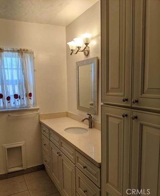 332 W Laurel, Compton, CA 90220 - bathroom featuring tile patterned floors, vanity, a chandelier, and a textured ceiling