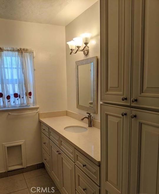 332 W Laurel, Compton, CA 90220 - bathroom with vanity, tile patterned floors, a chandelier, and a textured ceiling