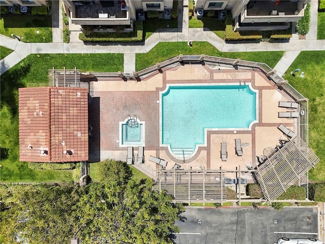 aerial view of property and surrounding area featuring a pool