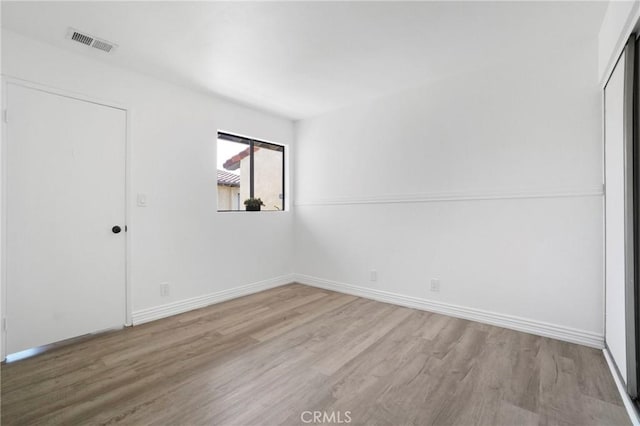 unfurnished bedroom featuring wood finished floors and baseboards