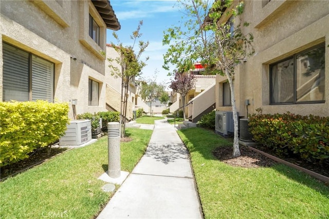 surrounding community with a yard, a residential view, and ac unit