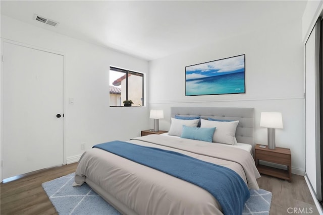 bedroom featuring wood finished floors and baseboards