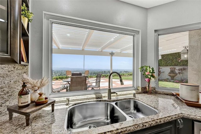 6142 E E W View Dr, Orange, CA 92869 - kitchen with a sink, plenty of natural light, light stone counters, and dark brown cabinetry