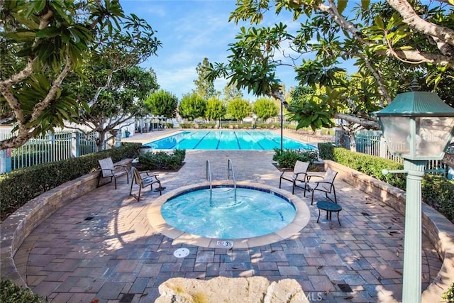 6142 E E W View Dr, Orange, CA 92869 - community pool featuring a community hot tub, fence, and a patio area