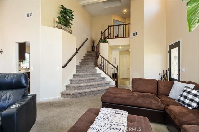 1065 Sycamore Ln, San Jacinto, CA 92582 - carpeted living room with a towering ceiling, stairway, and baseboards