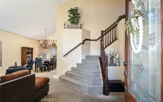 1065 Sycamore Ln, San Jacinto, CA 92582 - carpeted entrance foyer featuring a chandelier, stairs, and high vaulted ceiling