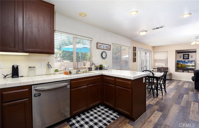1065 Sycamore Ln, San Jacinto, CA 92582 - kitchen featuring stainless steel dishwasher, dark wood finished floors, open floor plan, a sink, and a peninsula