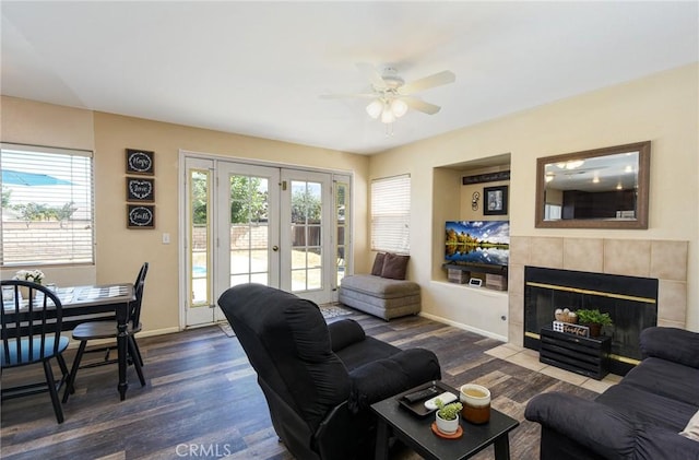 1065 Sycamore Ln, San Jacinto, CA 92582 - living area with a ceiling fan, dark wood-type flooring, french doors, a fireplace, and baseboards