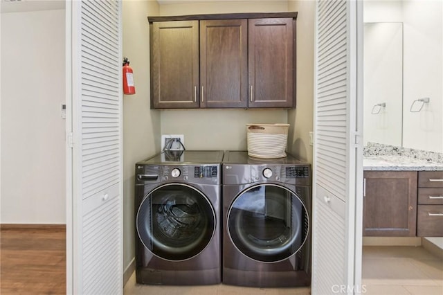 2205 Rockefeller Ln Unit B, Redondo Beach, CA 90278 - washroom featuring cabinet space, separate washer and dryer, and wood finished floors