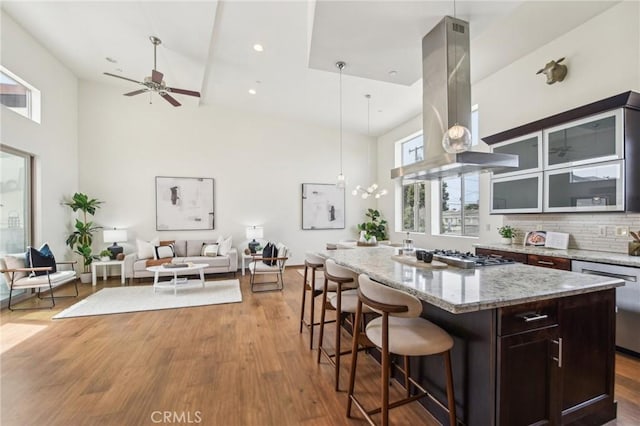 2205 Rockefeller Ln Unit B, Redondo Beach, CA 90278 - kitchen featuring island exhaust hood, stainless steel appliances, a high ceiling, a kitchen island, and open floor plan