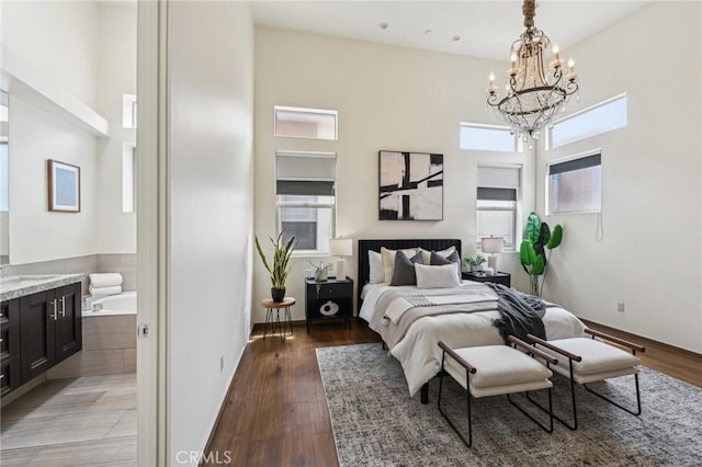 2205 Rockefeller Ln Unit B, Redondo Beach, CA 90278 - bedroom featuring a chandelier, light wood-style flooring, and a towering ceiling