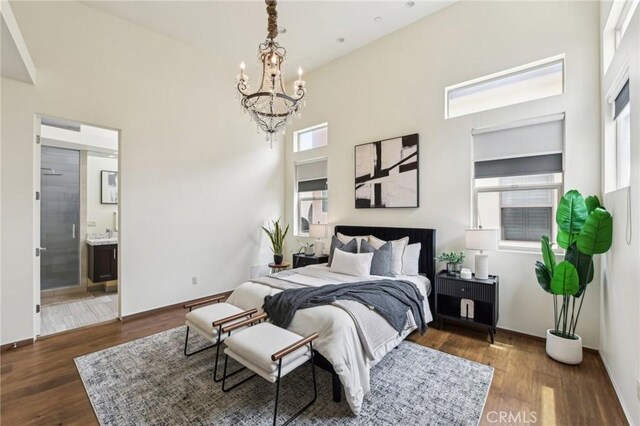 2205 Rockefeller Ln Unit B, Redondo Beach, CA 90278 - bedroom with a chandelier, a towering ceiling, dark wood-style flooring, and connected bathroom