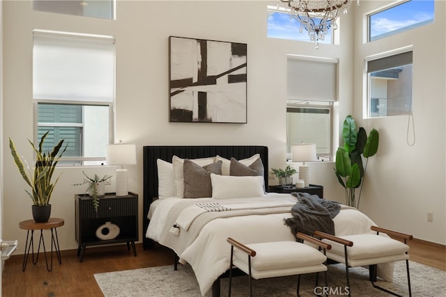 2205 Rockefeller Ln Unit B, Redondo Beach, CA 90278 - bedroom featuring a chandelier, multiple windows, and wood finished floors
