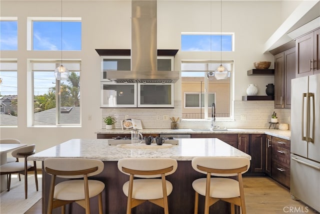 2205 Rockefeller Ln Unit B, Redondo Beach, CA 90278 - kitchen with freestanding refrigerator, open shelves, a high ceiling, a kitchen bar, and dark brown cabinetry