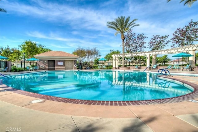community pool featuring a patio area, a pergola, and fence