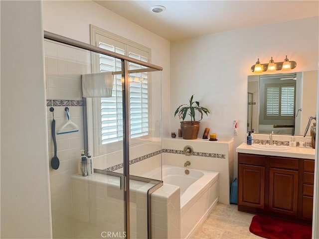 full bath with a stall shower, a garden tub, vanity, and tile patterned floors