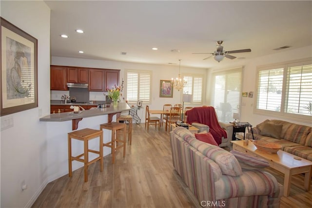 living area featuring ceiling fan, light wood finished floors, recessed lighting, a chandelier, and baseboards
