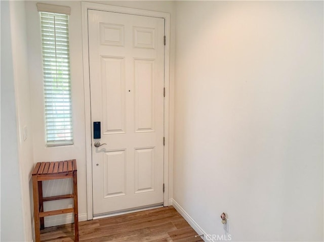 entryway featuring wood finished floors and baseboards