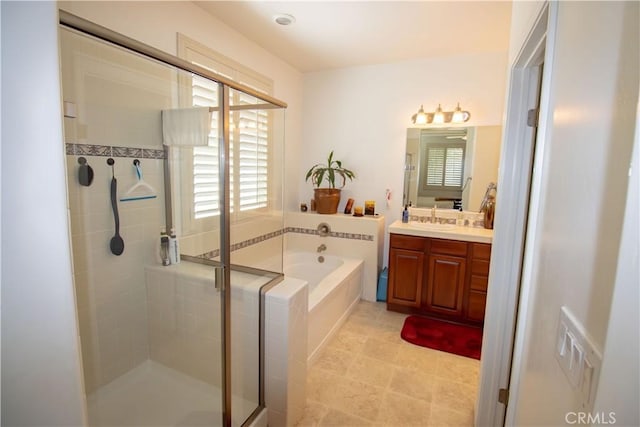 bathroom featuring a bath, a shower stall, and vanity