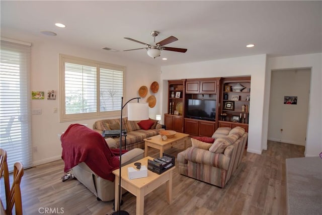 living room featuring a ceiling fan, light wood-style floors, recessed lighting, and baseboards