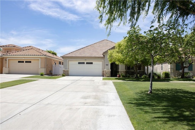 view of front of home featuring a front lawn, stucco siding, stone siding, an attached garage, and driveway