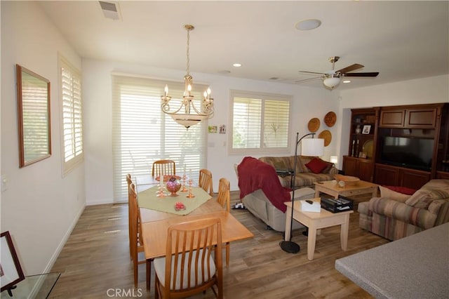 living area with a chandelier, light wood finished floors, a ceiling fan, baseboards, and recessed lighting