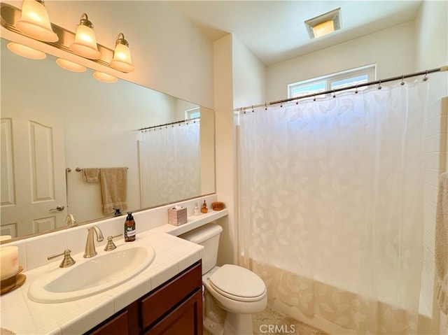 full bath with vanity, toilet, and shower / tub combo with curtain