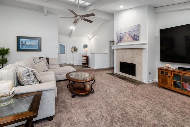 living area featuring a ceiling fan, carpet, a fireplace with flush hearth, a wainscoted wall, and recessed lighting