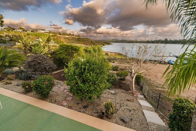 view of yard with fence and a water view