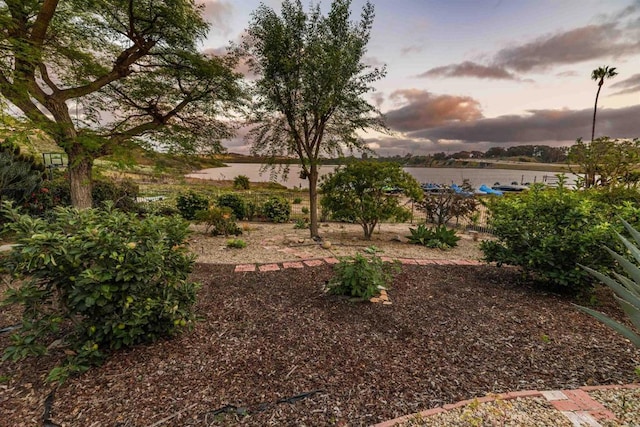 yard at dusk with a water view
