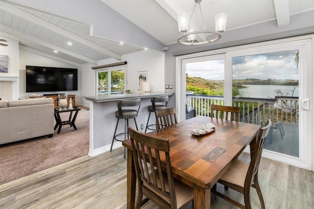 dining space featuring light wood-style floors, a chandelier, and baseboards