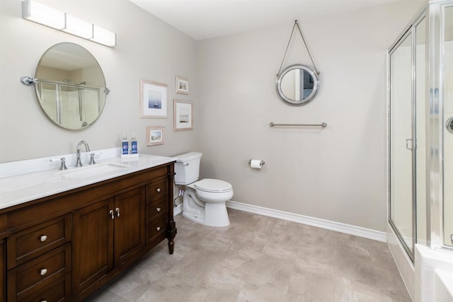full bath featuring a shower stall, toilet, baseboards, and vanity