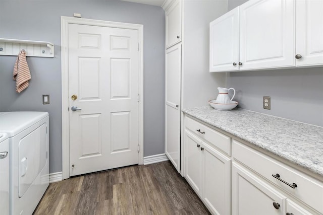 laundry area featuring independent washer and dryer, cabinet space, dark wood finished floors, and baseboards