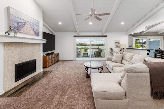 living room featuring plenty of natural light, a ceiling fan, a tile fireplace, baseboards, and recessed lighting