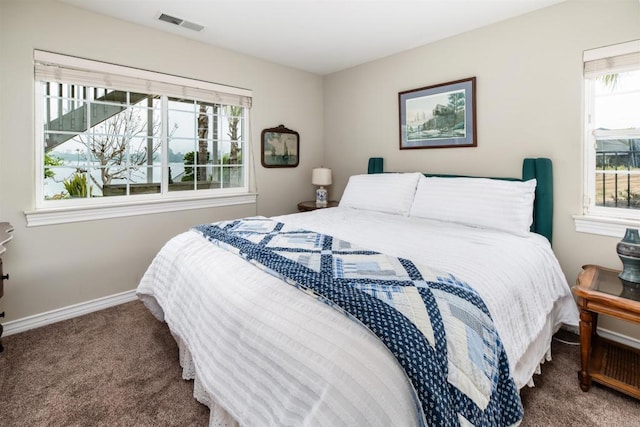 carpeted bedroom featuring baseboards