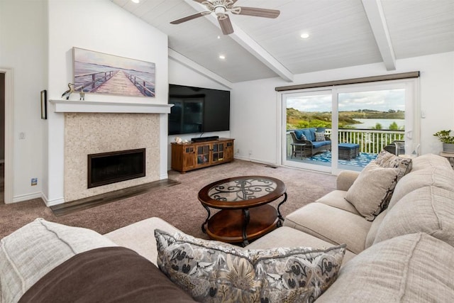 carpeted living area with a ceiling fan, a tiled fireplace, baseboards, and recessed lighting