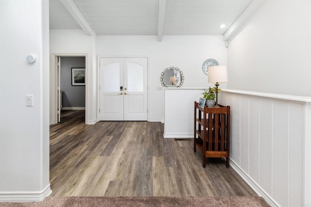 additional living space featuring beamed ceiling and wood finished floors