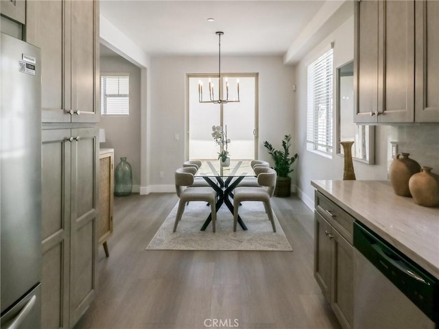 617 E Walnut Ave, Monrovia, CA 91016 - dining area with wood finished floors, baseboards, and a chandelier