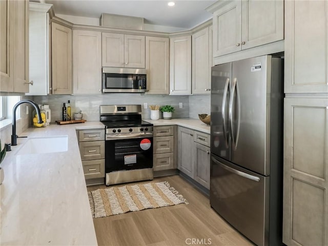 617 E Walnut Ave, Monrovia, CA 91016 - kitchen featuring stainless steel appliances, a sink, wood finished floors, decorative backsplash, and recessed lighting