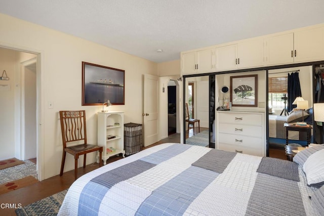 4129 Marmion Way, Los Angeles, CA 90065 - bedroom with arched walkways, baseboards, and wood finished floors
