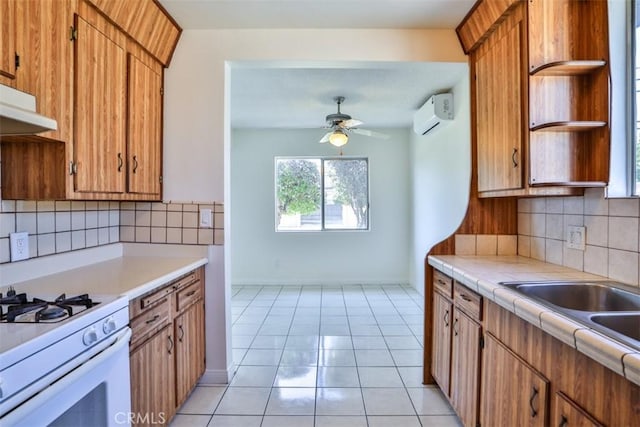 kitchen with a wall mounted air conditioner, open shelves, gas range gas stove, ceiling fan, and backsplash