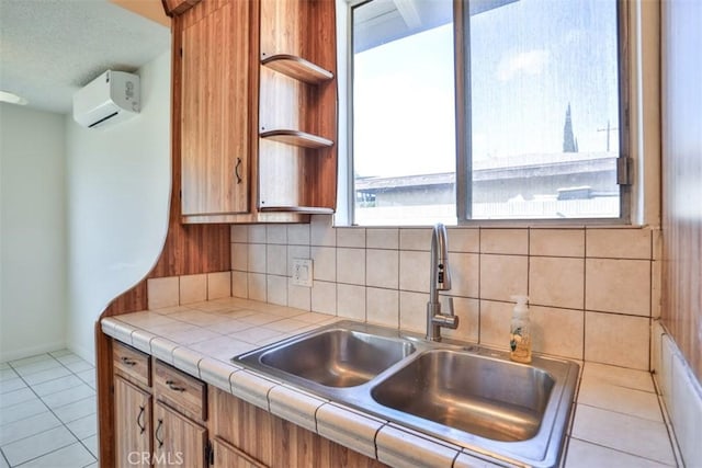 kitchen with a sink, tile countertops, open shelves, a wall mounted air conditioner, and decorative backsplash