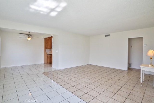 spare room featuring light tile patterned flooring and ceiling fan