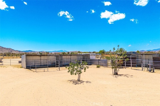 60849 Duvall Dr, Joshua Tree, CA 92252 - view of yard featuring an exterior structure, a mountain view, and an outdoor structure